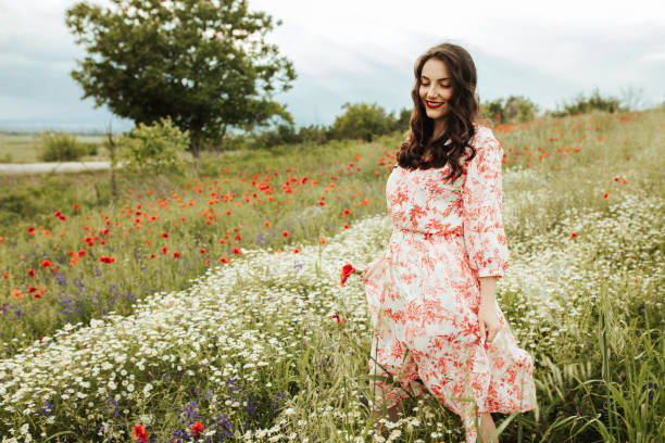 istock Young female beauty in the white fields of chamomile 1237146748