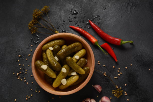 istock Homemade small  cucumbers, fermented, salted or marinated pickles with garlic, chili and dill 1237152680