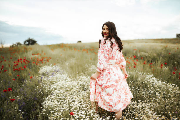 istock Young female beauty in the white fields of chamomile 1237154822