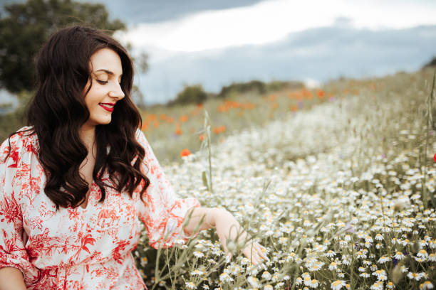 istock Young female beauty in the white fields of chamomile 1237155334