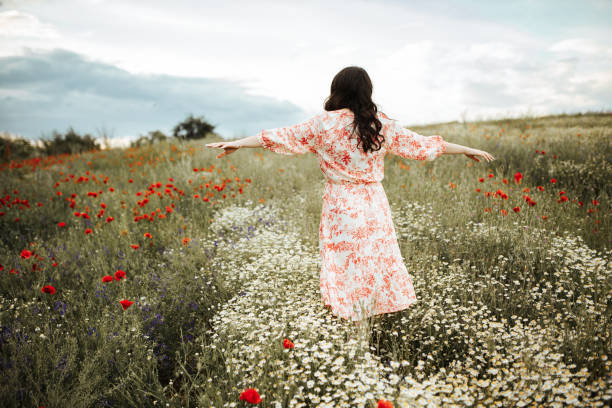 istock Young female beauty in the white fields of chamomile 1237155355