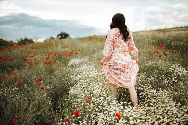 istock Young female beauty in the white fields of chamomile 1237156454