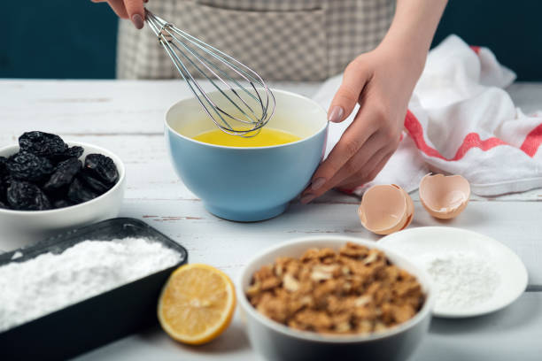 istock Female hands beat egg whites. Ingredients for meringue roll cooking. 1237165910