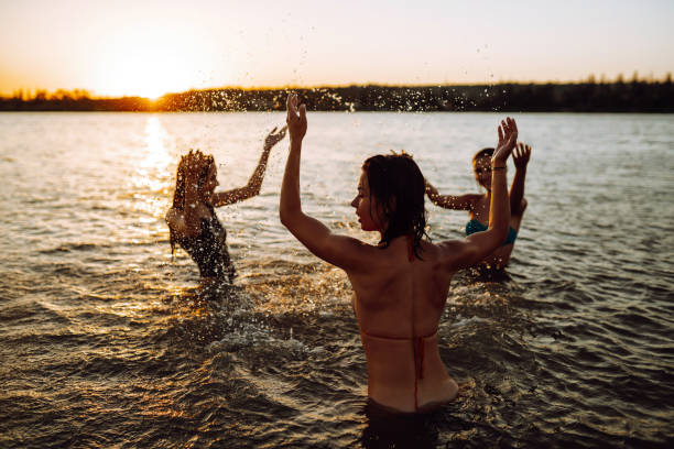 istock Three young girls splashing water in the sea. 1237175671