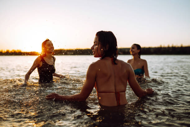 istock Three young girls splashing water in the sea. 1237175686