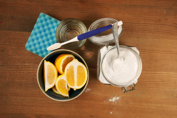 baking soda lemon vinegar top view jar of baking soda vinegar lemon and cleaning sponge carbonate mineral stock pictures, royalty-free photos & images