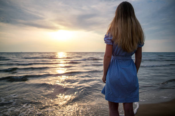 istock Summer vacation. Looking at sunset near sea 1237239747