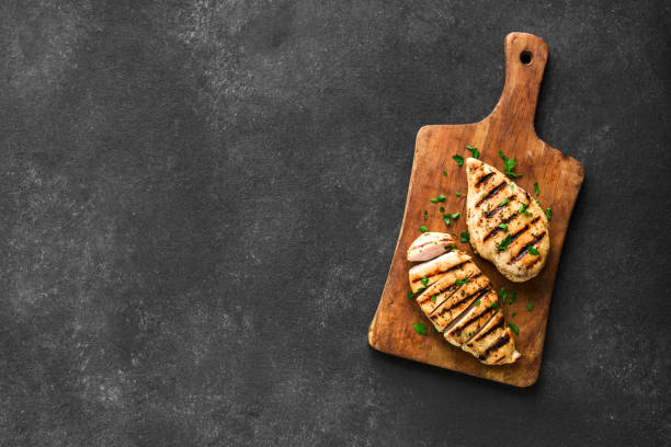 Grilled chicken fillet Grilled chicken breast, fillet, steak on wooden board, top view, copy space. Healthy keto, ketogenic meal, homemade bbq chicken meat ready to eat. marinated photos stock pictures, royalty-free photos & images