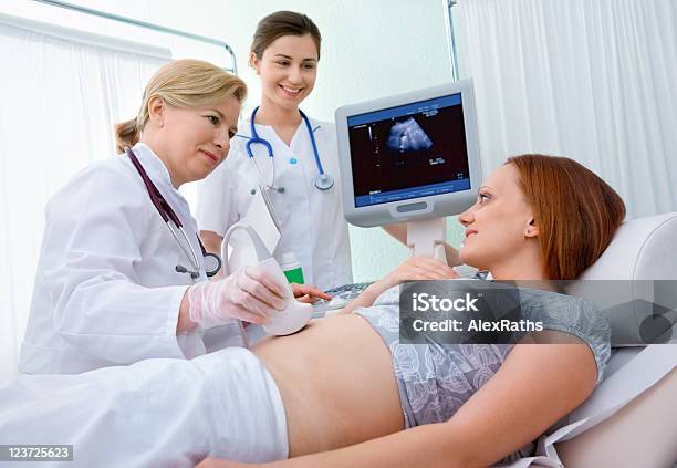 Medical Team Diagnosing A Womans Pregnancy Stock Photo - Download Image Now - 30-39 Years, Abdomen, Adult