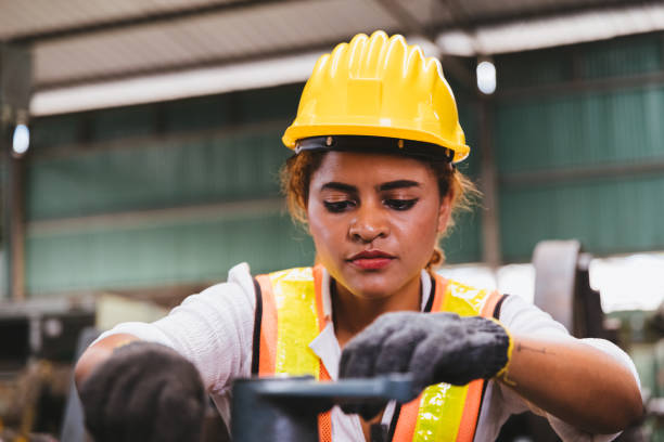 istock Industrial factory maintenance engineers dark skinned woman inspect relay protection system of machinery with copy space for your text. Industry, Maintenance, Engineering and construction concept. 1237270196