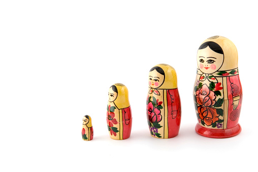 Four wooden Russian dolls in a line