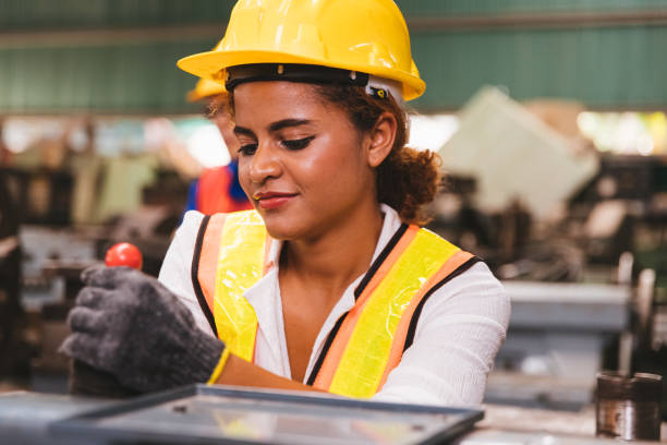 istock Industrial factory maintenance engineers dark skinned woman inspect relay protection system of machinery with copy space for your text. Industry, Maintenance, Engineering and construction concept. 1237280704