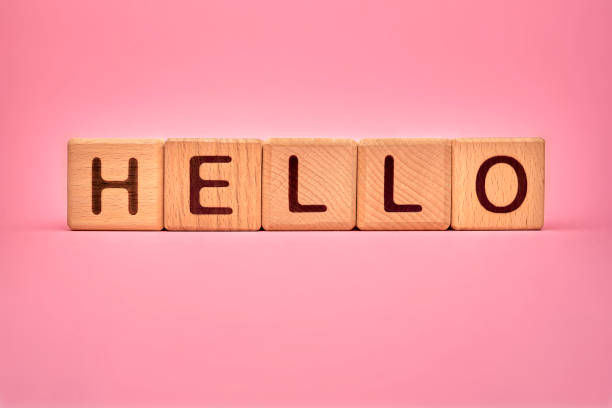 istock Hello word made with building blocks, business concept. Text Hello on pink background. Global mass gathering allowed. Greeting background, Hospitality, hello sign for visitors, guests, clients 1237295350