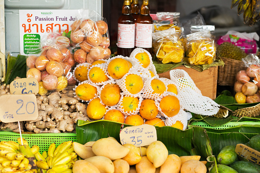 Offered thai fruits, ginger and honey at market stall in Bangkok