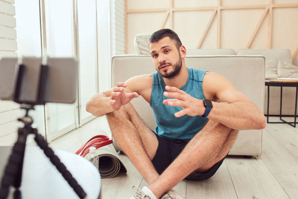 istock Handsome gentleman giving online workout consultation at home 1237301258