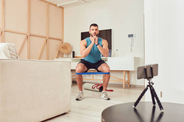 istock Athletic young man doing exercise with elastic fitness band 1237301272