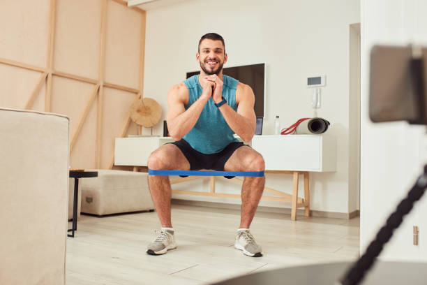 istock Joyful athletic gentleman doing exercise with elastic fitness band 1237301282