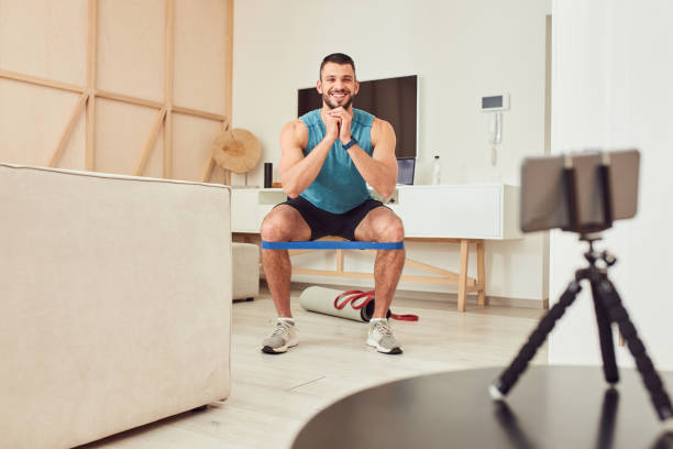 istock Smiling young man doing exercise with elastic fitness band 1237301283