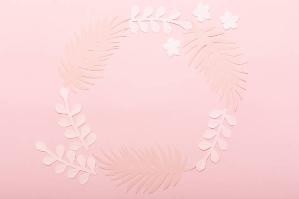 Floral greeting card on pink background. Pastel paper flowers flat lay, top view