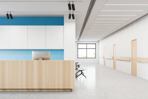 Reception desk in hospital corridor with doors