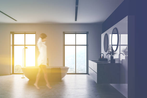 istock Woman walking in white and black bathroom 1237311037