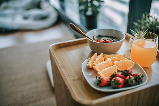 healthy breakfast with fruit orange, strawberry, vegetable,  , yogurt  on table