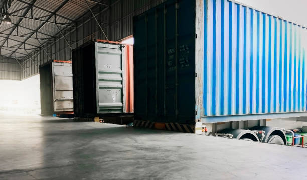 istock Container truck docking load cargo shipment at the warehouse. Road freight industry transport shipment goods, warehouse logistics. 1237319604