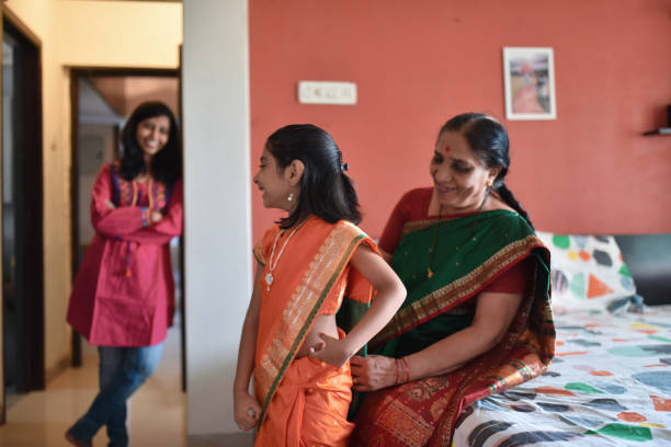istock Grandmother wearing sari to granddaughter 1237335257
