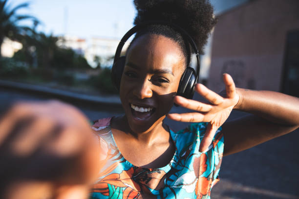 istock Happy woman dancing listening to music 1237338340