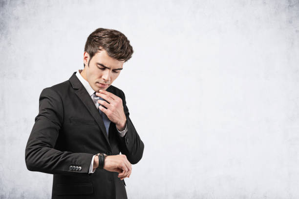 istock Thoughtful businessman looking at watch, mock up 1237339379
