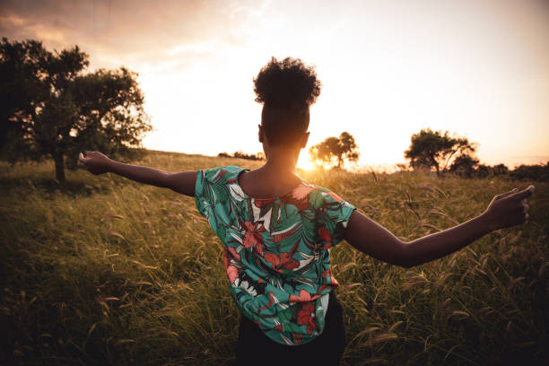 istock Woman with open arms breathing in the nature 1237340425