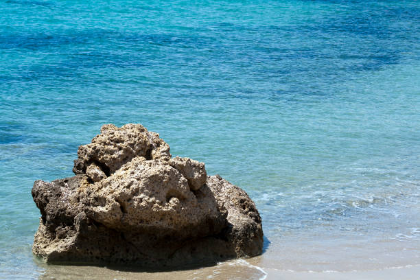 istock Big rock among blue sea on the beach 1237343581
