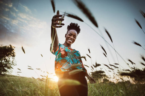 woman with open arms breathing in the nature - thinking green imagens e fotografias de stock