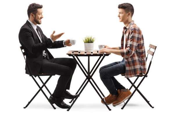 istock Businessman sitting in a cafe with a young male student 1237354020