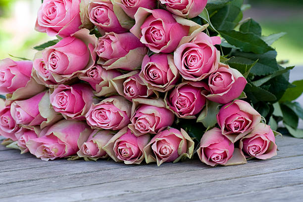 istock Beautiful roses bouquet lying on a wooden table 123736020