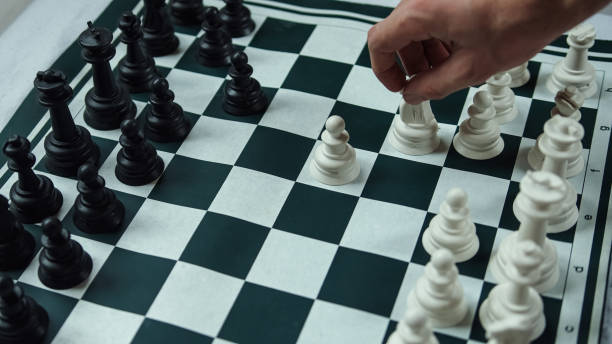 istock Black and white chess pieces one person making pawn move chess concept 1237380301