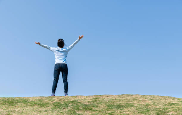 istock Young woman relaxing with arms outstretched 1237384787