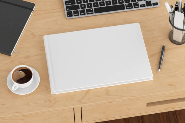 istock Book cover mock up. Workspace on wooden desk with cup of coffee 1237390081