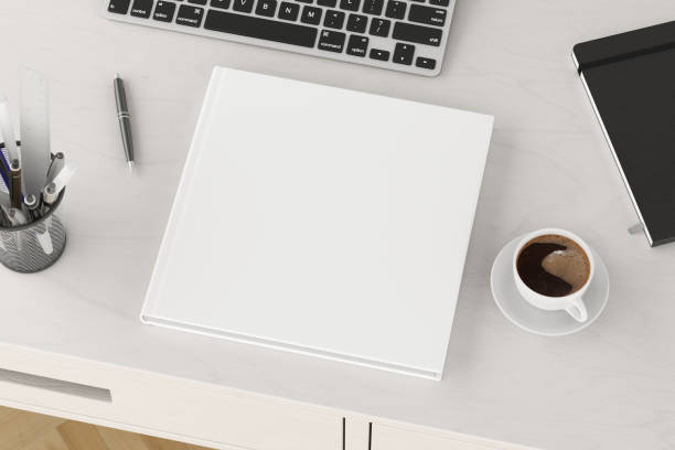 istock Book cover mock up. Workspace on wooden desk with cup of coffee 1237390590