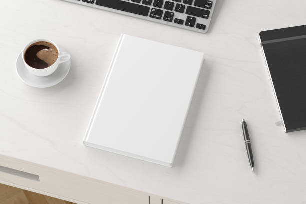 istock Book cover mock up. Workspace on wooden desk with cup of coffee 1237390594
