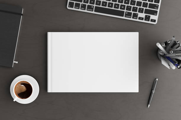 istock Book cover mock up. Workspace on wooden desk with cup of coffee 1237391108