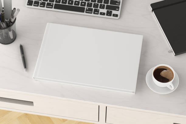istock Book cover mock up. Workspace on wooden desk with cup of coffee 1237391625