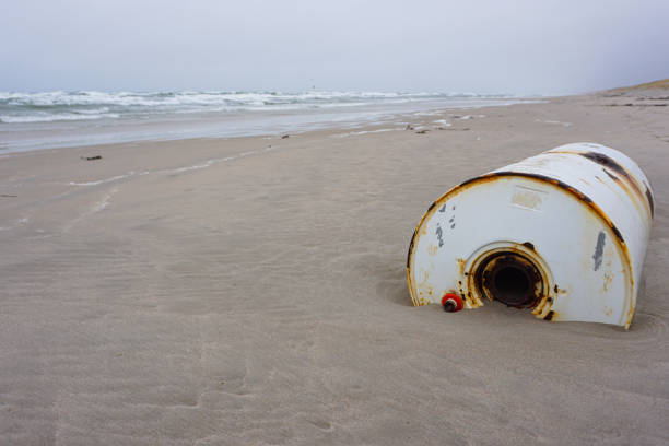 istock Rusty barrel on a seaside after sea storm. Environmental pollution 1237406783