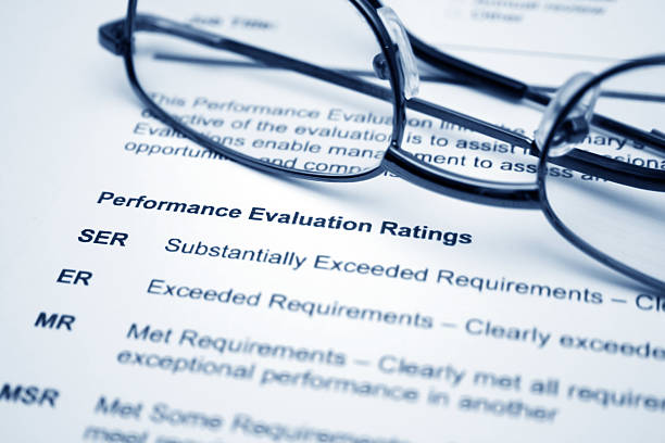 Performance evaluation paper and a pair of glasses stock photo