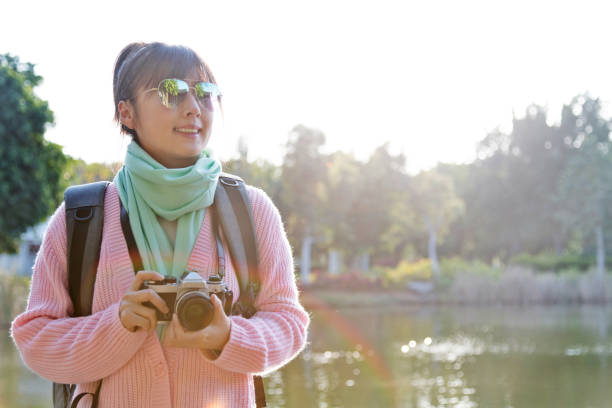 istock Woman taking photos by the lake 1237420789