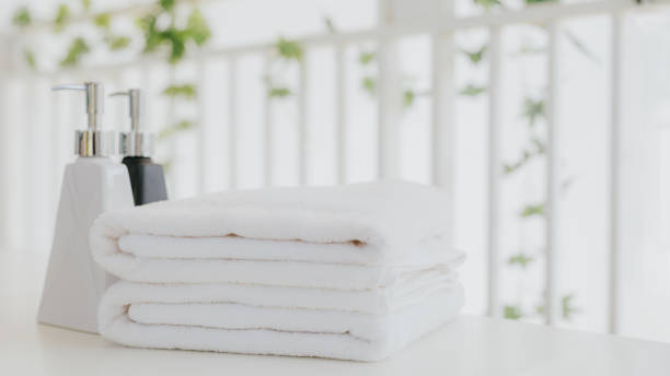 istock Shampoo and shower cream bottle with towel 1237437526