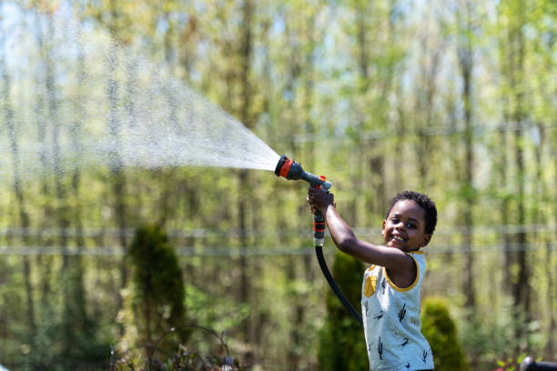 Mature woman gardening with her son, Quebec, Canada