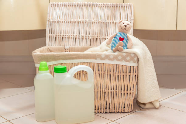 istock A stuffed toy teddy bear is sitting on laundry basket in the bathroom next to detergent and rinse aid. Home laundry 1237467559