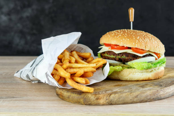 istock Burger vegetarian with spinach cutlet, cheese and vegetables. Fried potato in eco paper bag. Light fast food concept. 1237467643