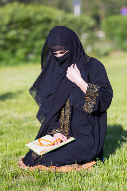 istock Islamic woman prayer in a city park. 1237467984